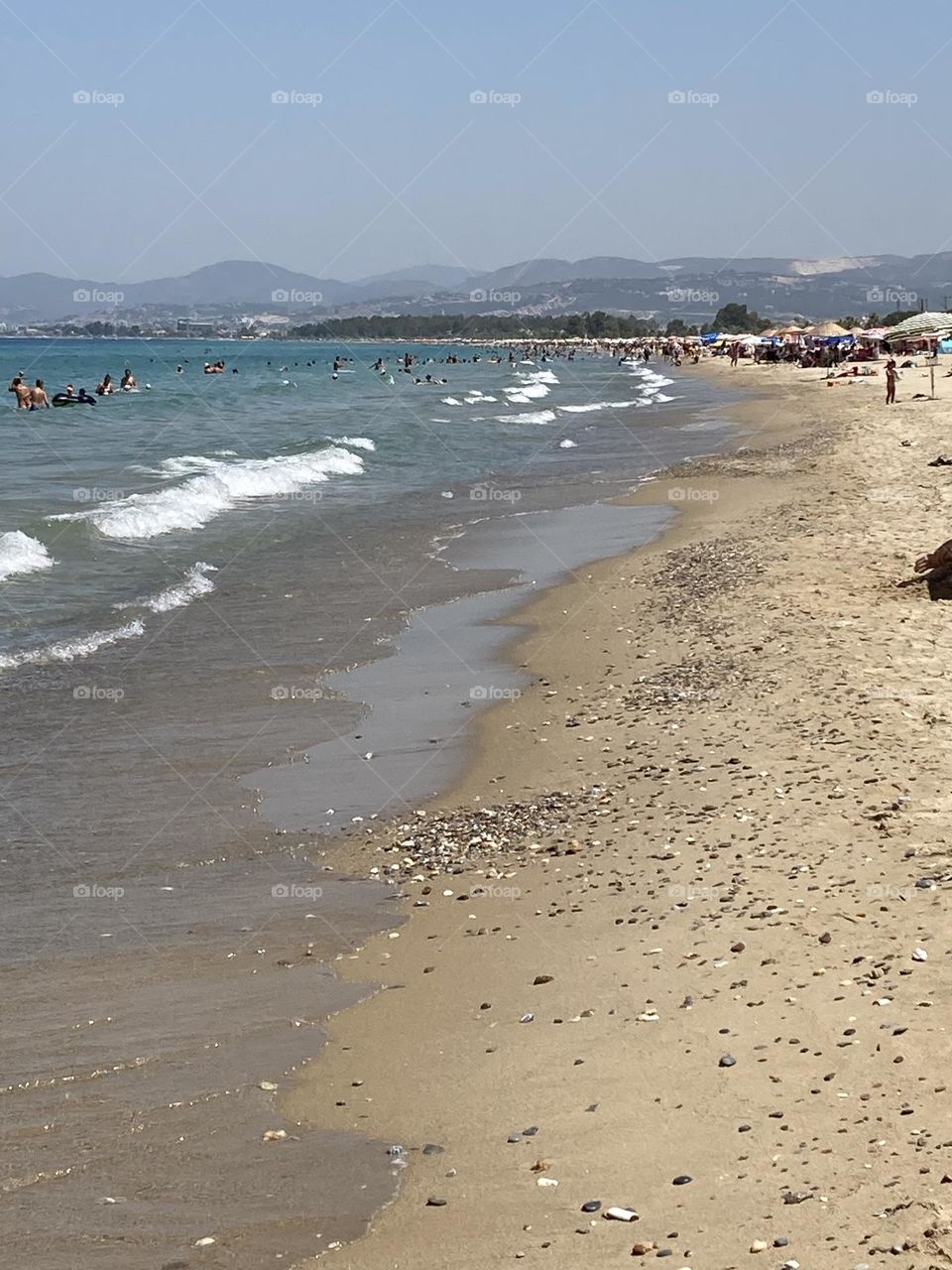 Sunny holidays I’m Turkey. Walk in the cute city and charming streets by the beach in Kusadasi. perfect blue sky and ocean view. Beach and the shore. To travel is to live. Gorgeous tall palm trees.