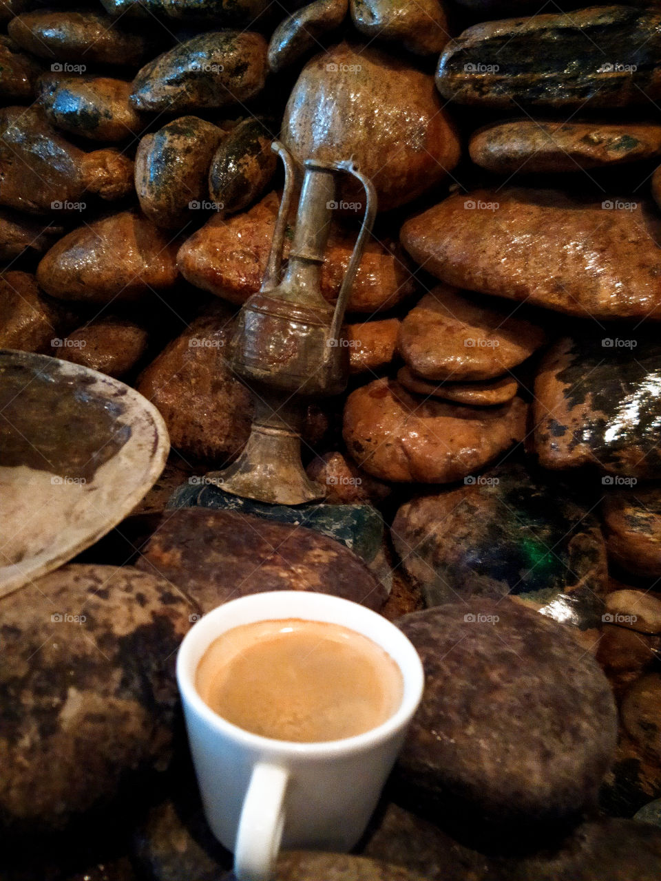 Cup of coffee among stones
