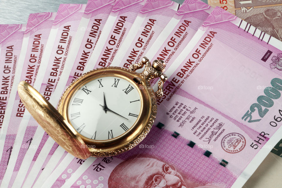 Indian currency rupee with antique watch