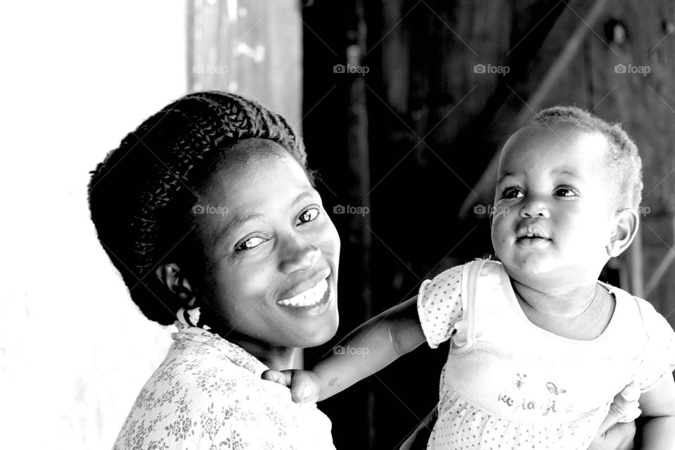 Mother and Daughter . Came across this woman Brest feeding while visiting an orphanage in Uganda. She had the most welcoming smile. 