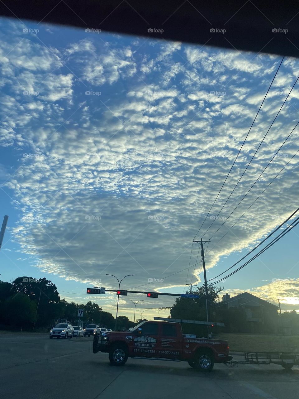 A morning sky bursts with clouds over the waking city. 