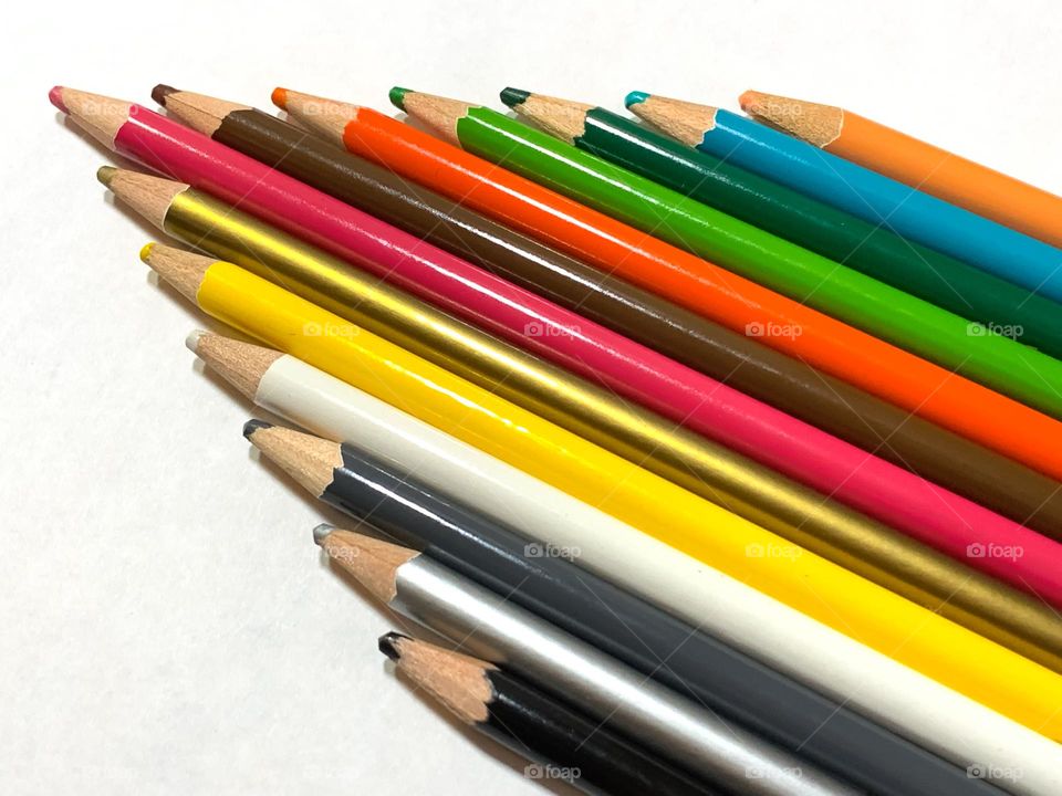 Colored pencils against white background.