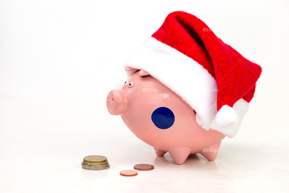 piggy bank in red Christmas hat