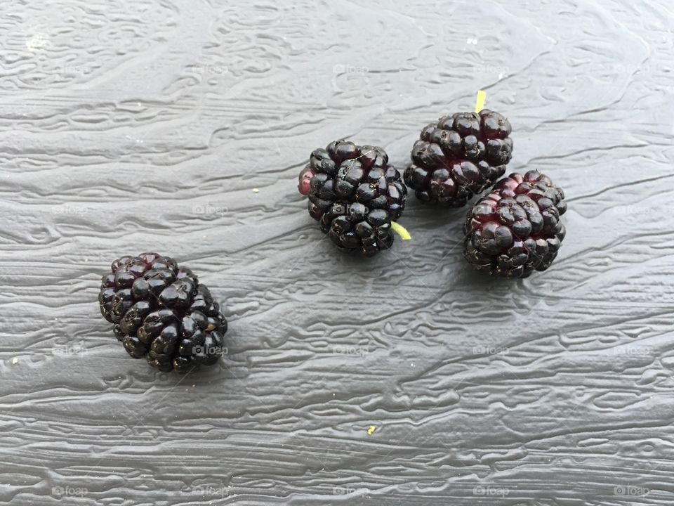 Fresh picked blackberries on a textured gray table