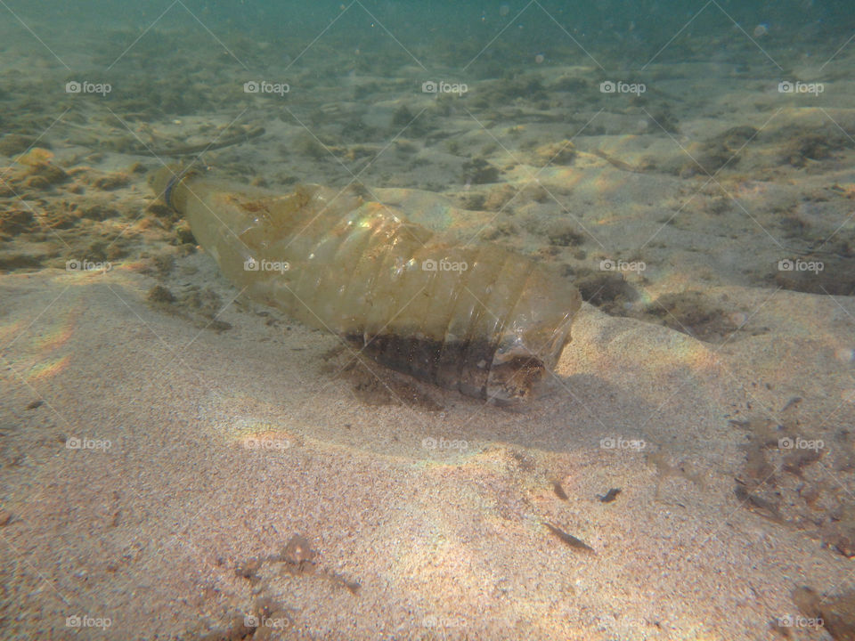 plastic bottle underwater. plastic bottle on the bottom of the sea