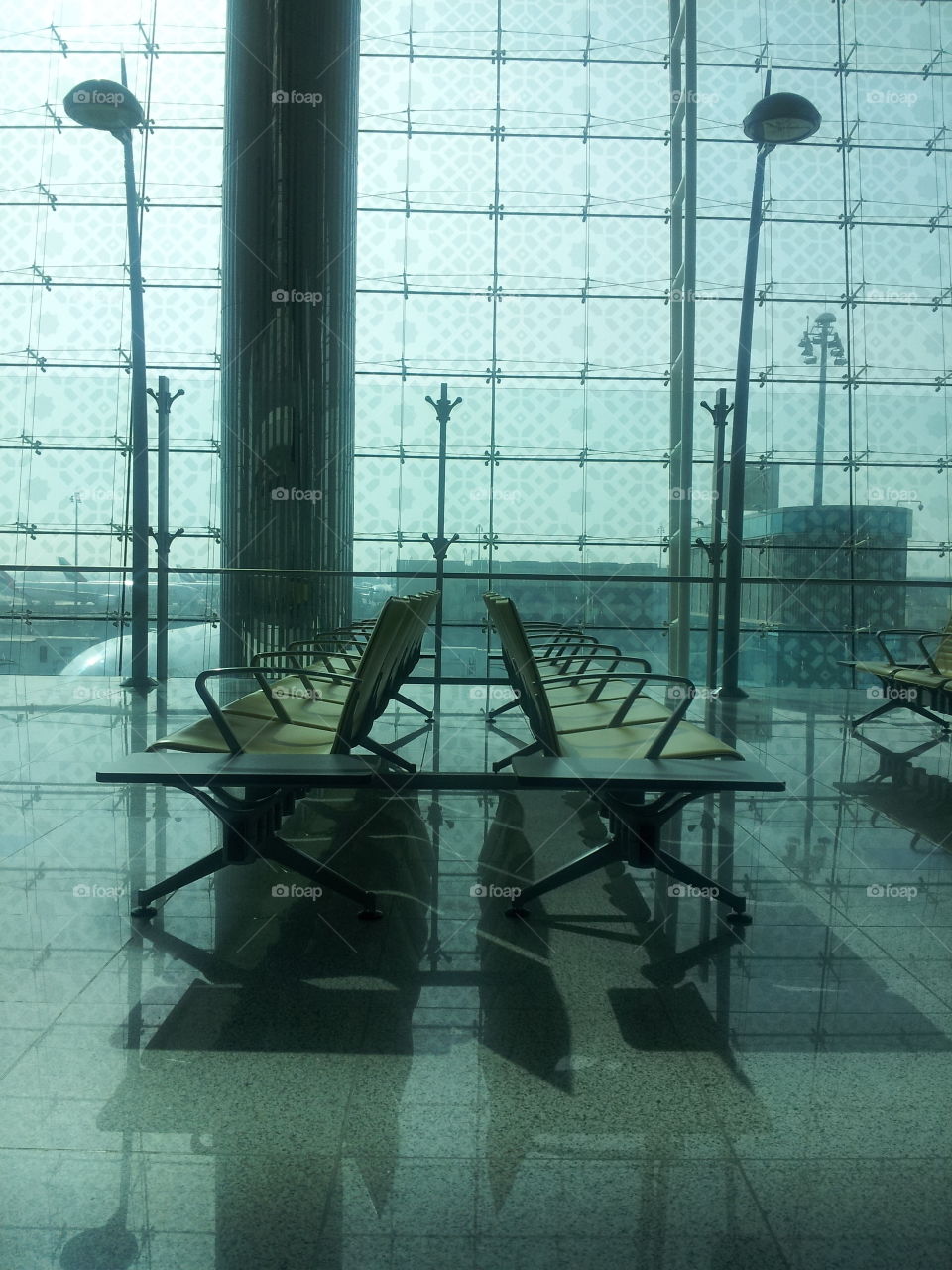 Calm at Airport. This was taken at the Dubai airport. It was unusually empty that day. Glossy floor, Unoccupied seats, Calm lighting. Best I could do was just capture the peaceful moment.