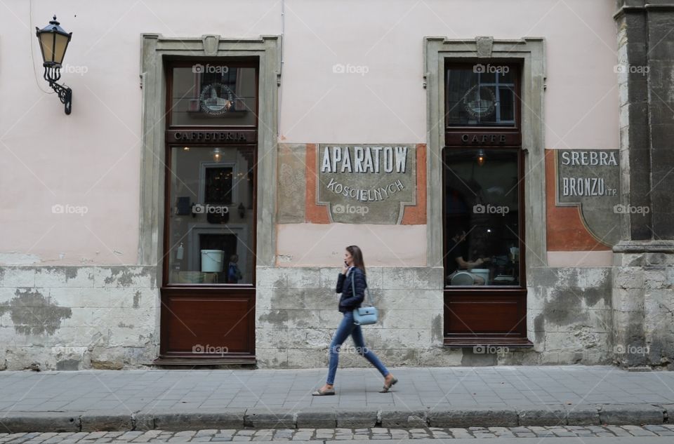 A woman walks past the Lviv Coffee Mining Manufacture cafe, in the old town of Lviv, Ukraine