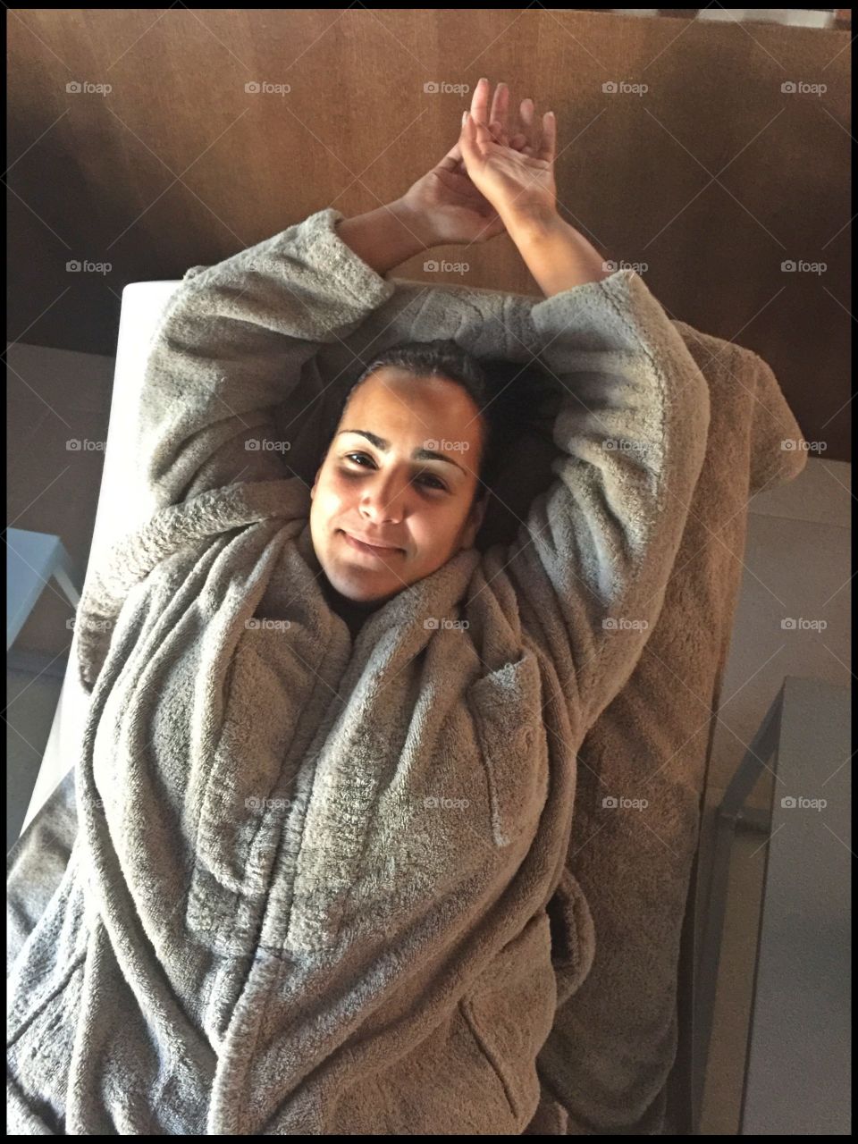 Woman lying on deck chair in spa room
