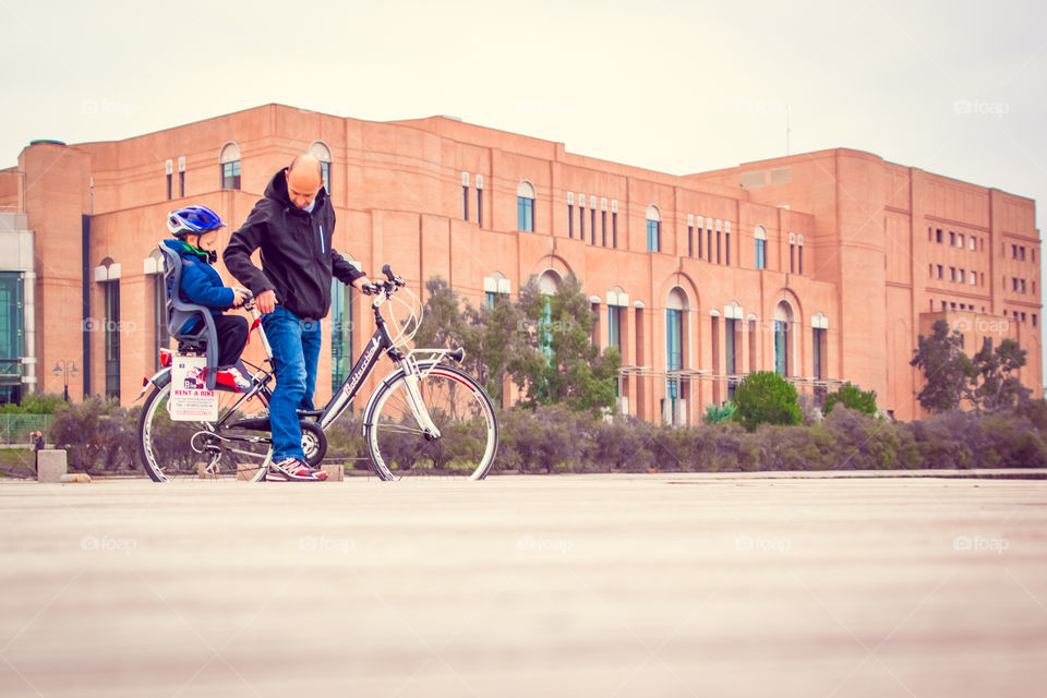 Ride With Little Boy In The Seat Bicycle Behind His Father
