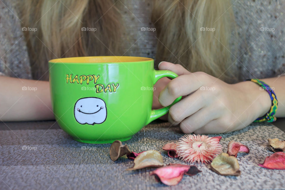 cup of hot tea in the hands of women