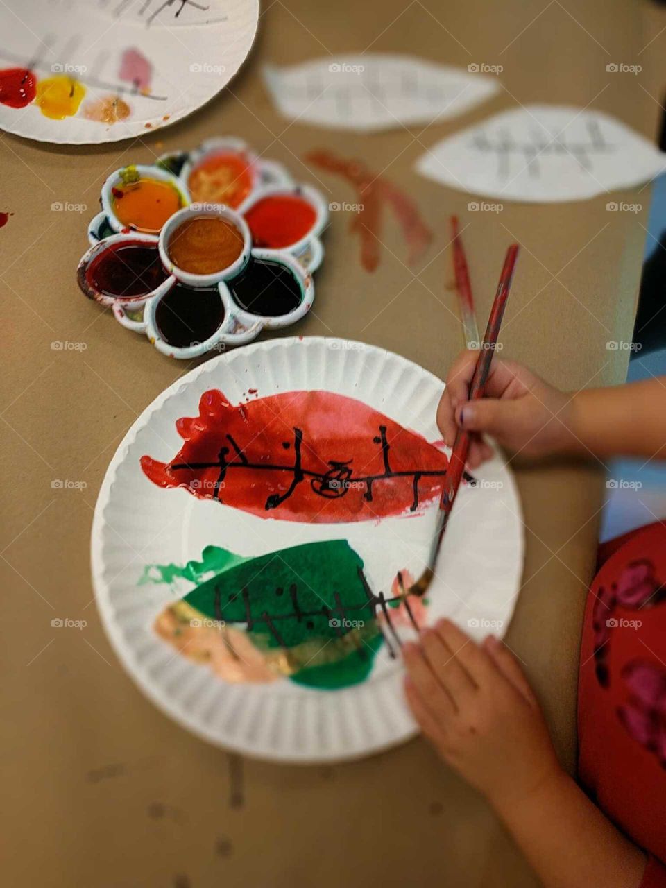 A small child practices painting at the MFA Boston.