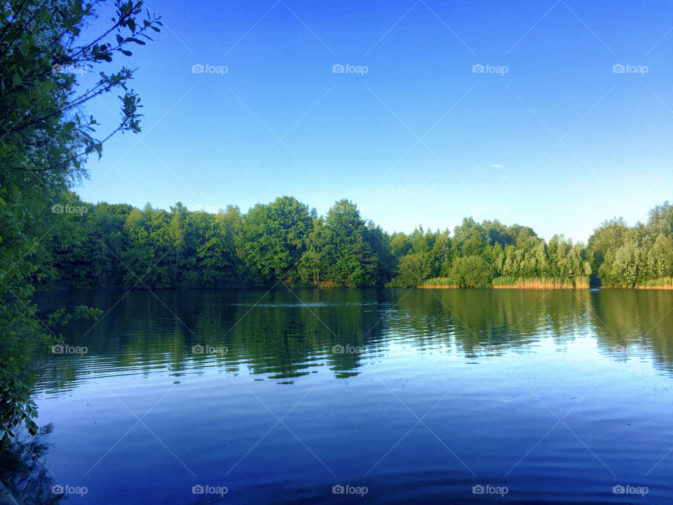 Blue sky reflected in blue water of a lake