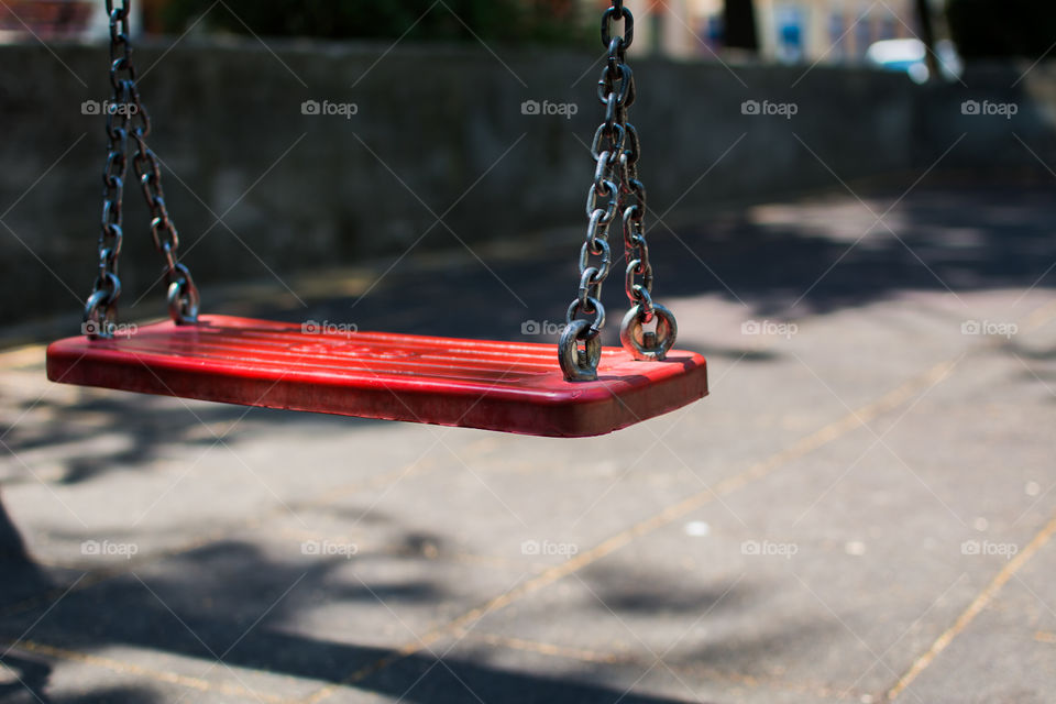 Red swing in park