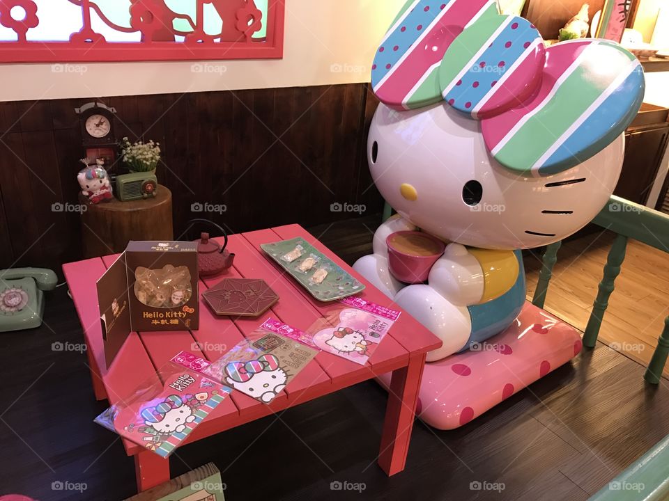Hello kitty having tea at a cafe, cartoons, cute, colorful, afternoon tea 