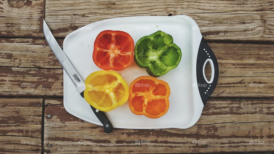 High angle view of bell peppers with kitchen knife