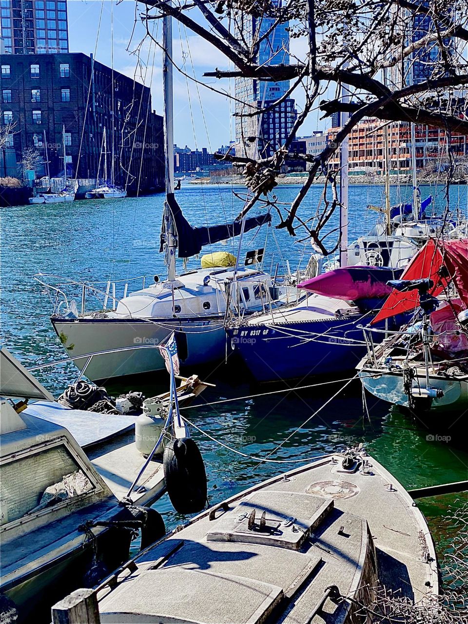 The boats at “Newtown Creek” in LIC, Queens by the “Pulaski Bridge” offer sheer endless photo opportunities. The bright afternoon sun makes the water sparkle vivaciously. 2023. Hypnotic Productions