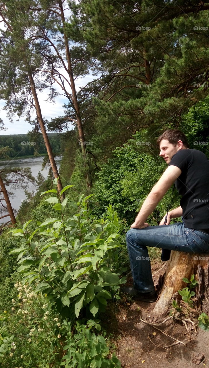 man sitting on a cliff