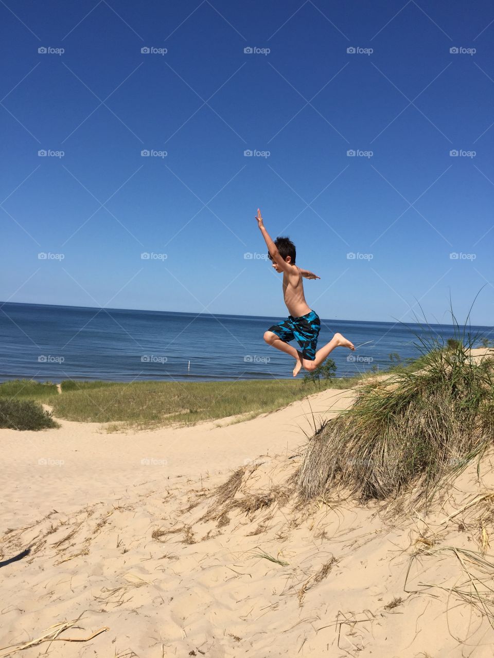 Jumping sand dunes . My nephew sand dune jumpin on lake michigan 