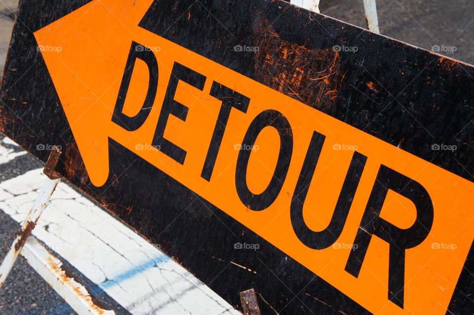 Orange on black detour arrow at street