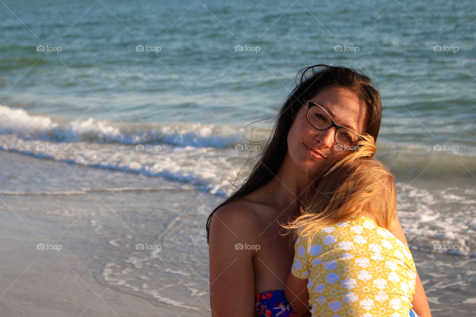 Happy mother hugging her daughter