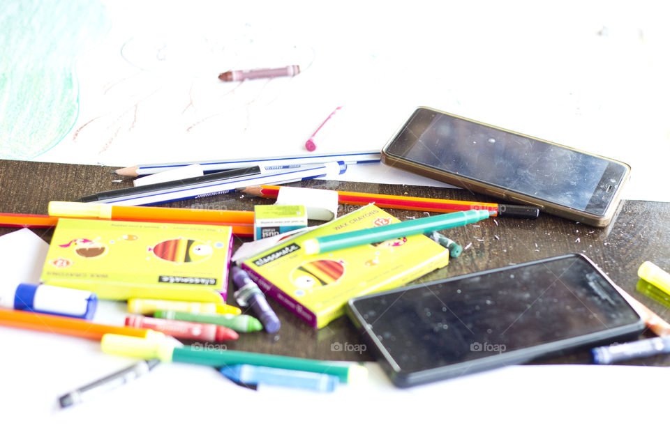 Smartphones and stationery on table