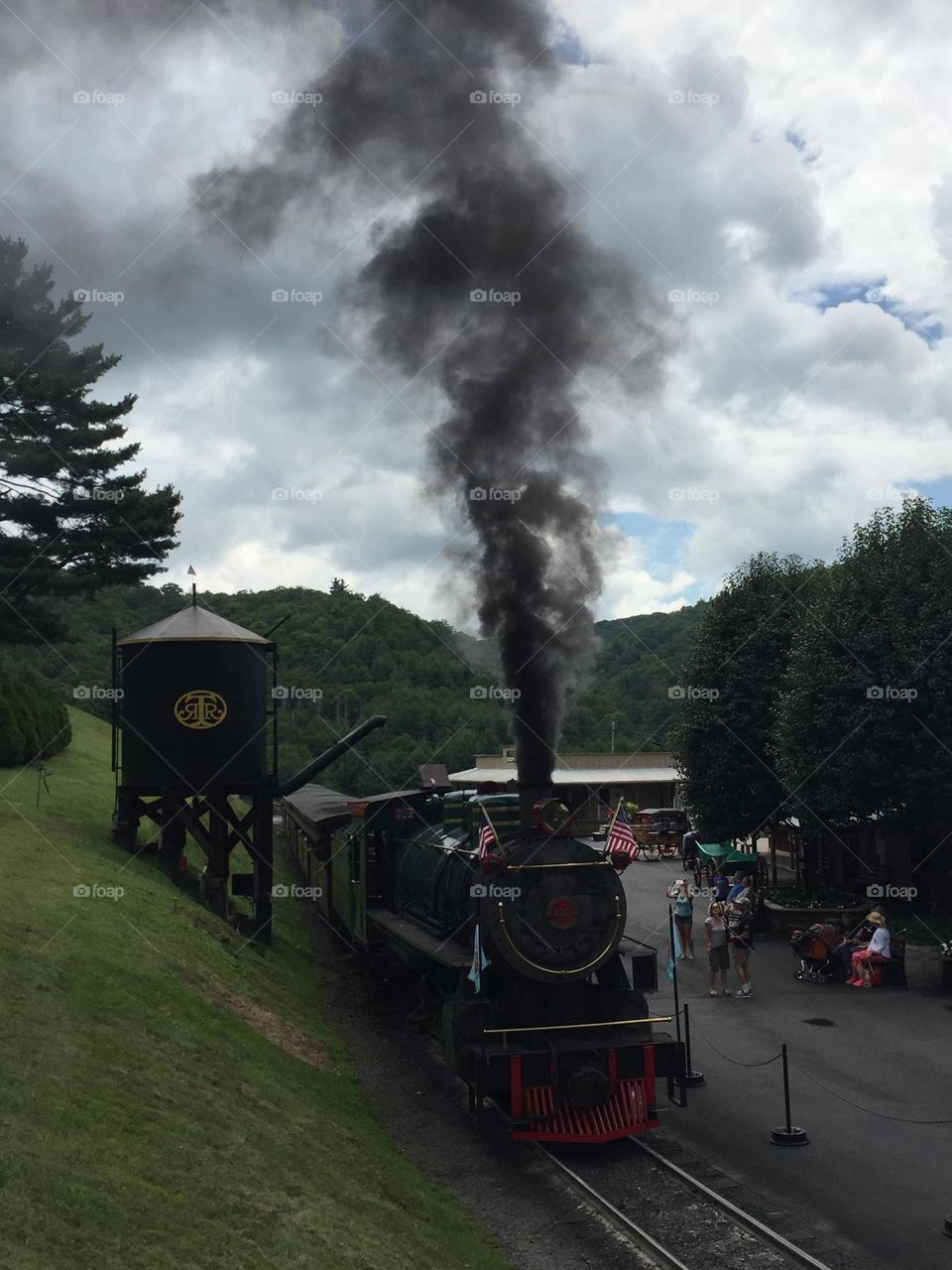 Smoky train by water tower