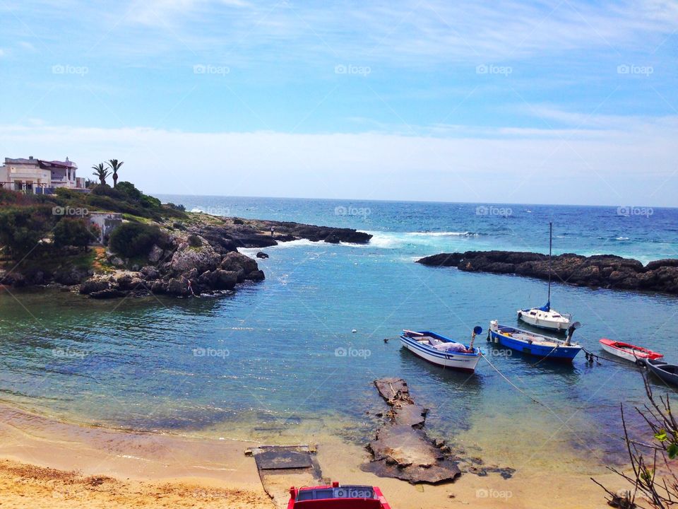 Sailboats in a old port. Sailboats are una old port between the rocks near the beach