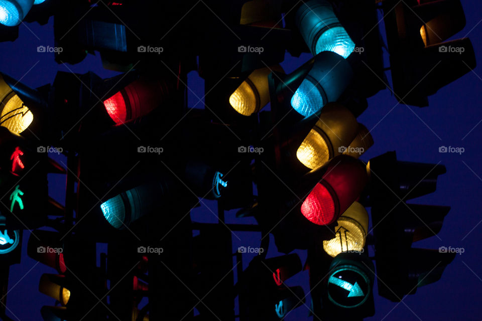 Many multicolored traffic lights at night