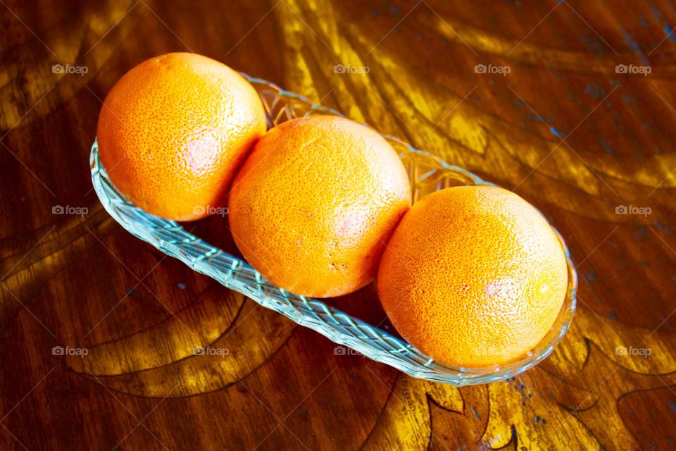 Oranges in a row on table