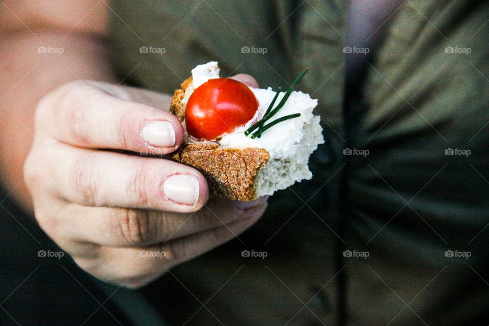 Mid section of person holding sandwich