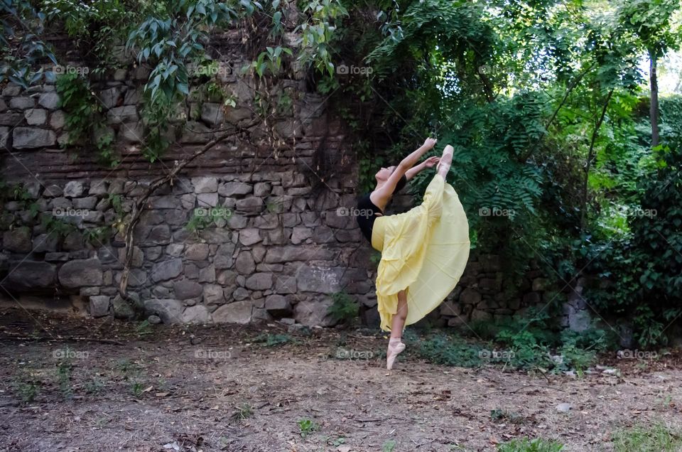 Young Female Ballerina Dancing Outside in Nature