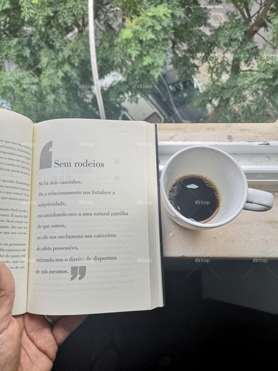 Reading with coffee in the apartment window
