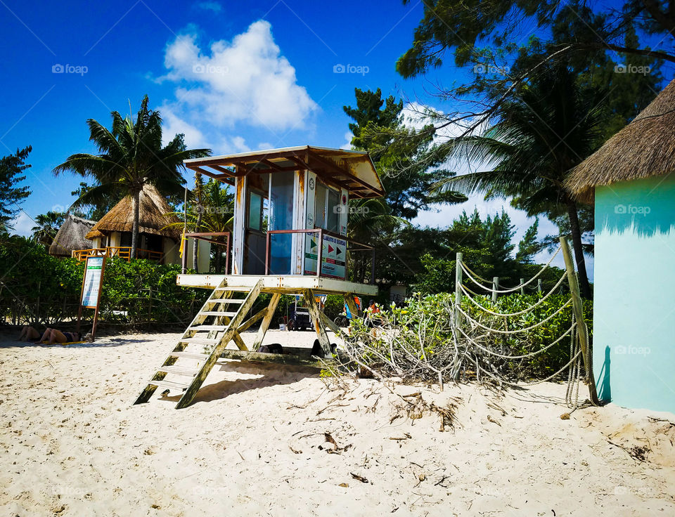 Lifeguards napping under their tower