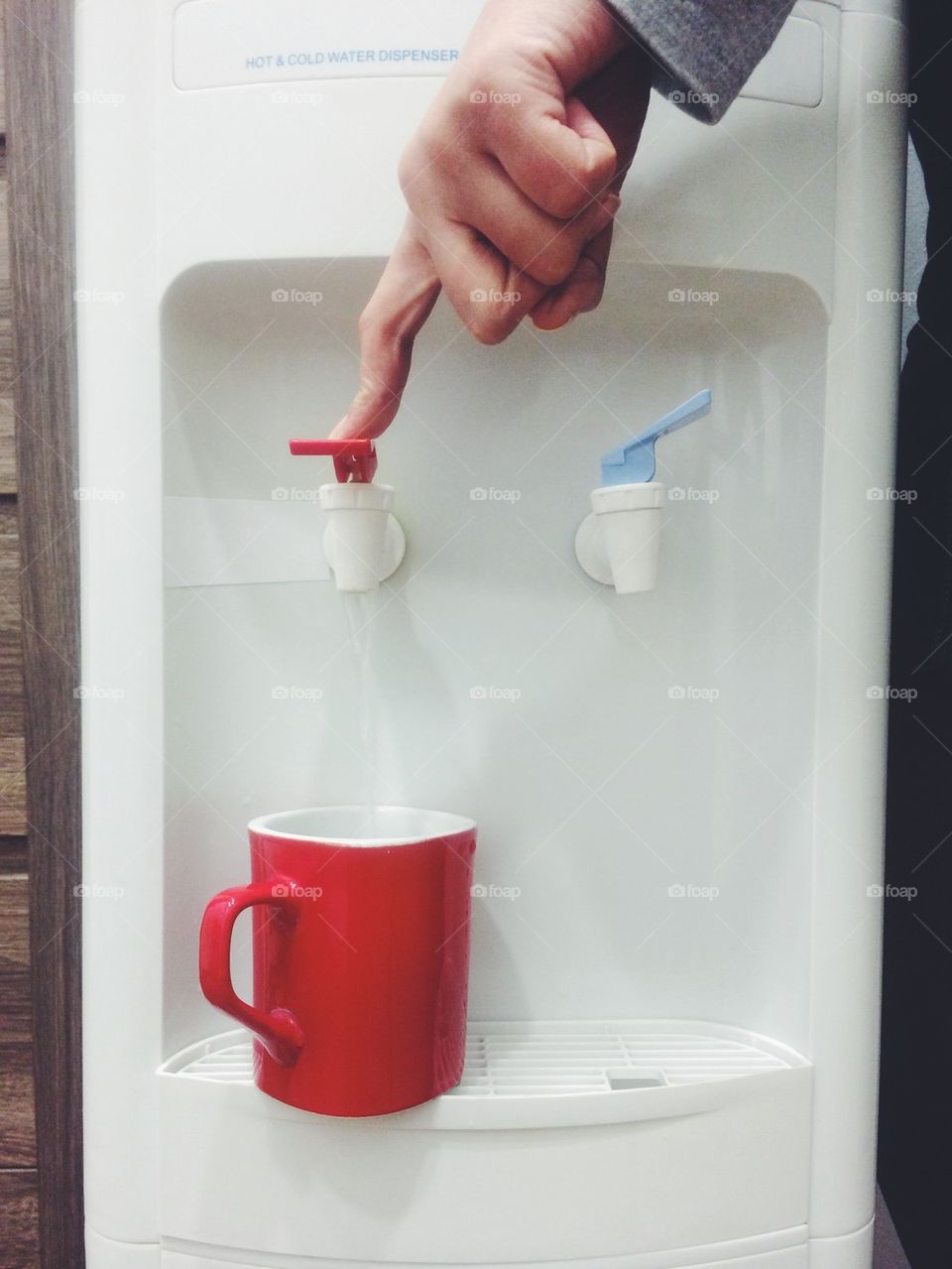Woman filling up a mug with hot water