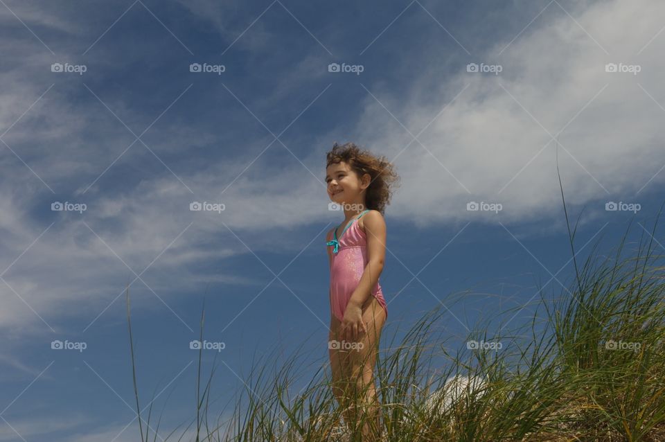 Little girl standing in the dunes