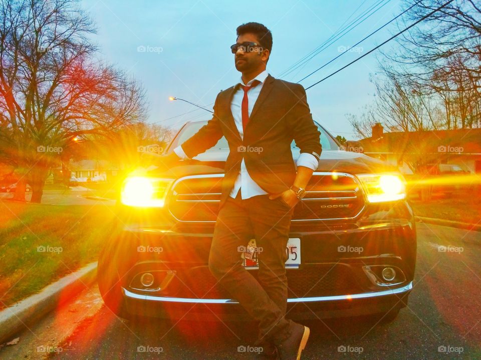 Handsome man standing in front of car
