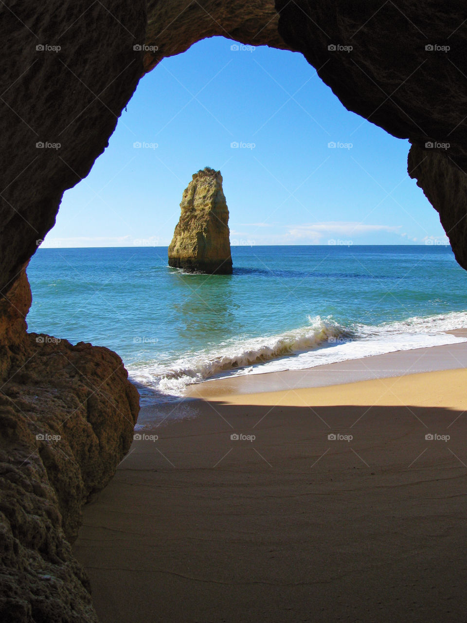 Scenic view of sea seen through cave