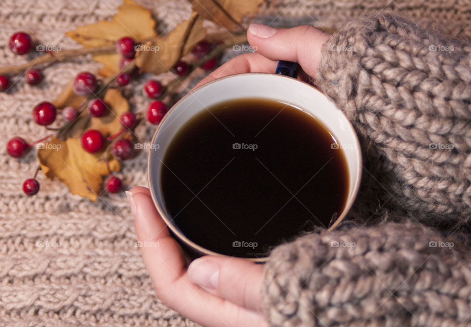 a cup of coffee in the winter in the hands of a girl