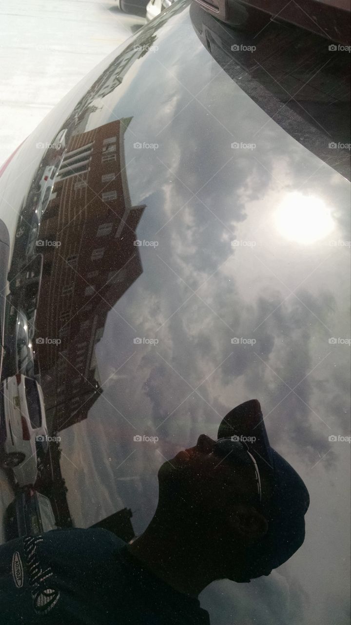 Reflection. this is a reflection off of a car window catching the sky, the sun and the Newton NJ courthouse