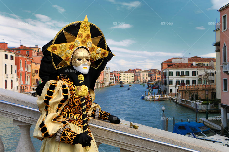 Person in costume standing near canal