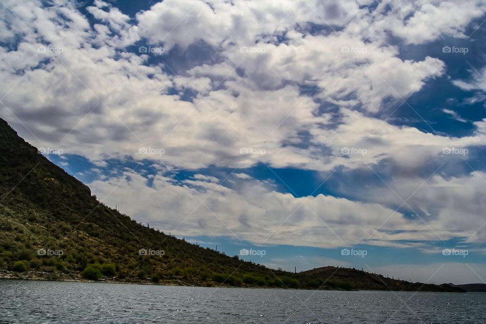 Stunning clouds on a beautiful day on the lake in Arizona desert, just a hint of land and mountains 