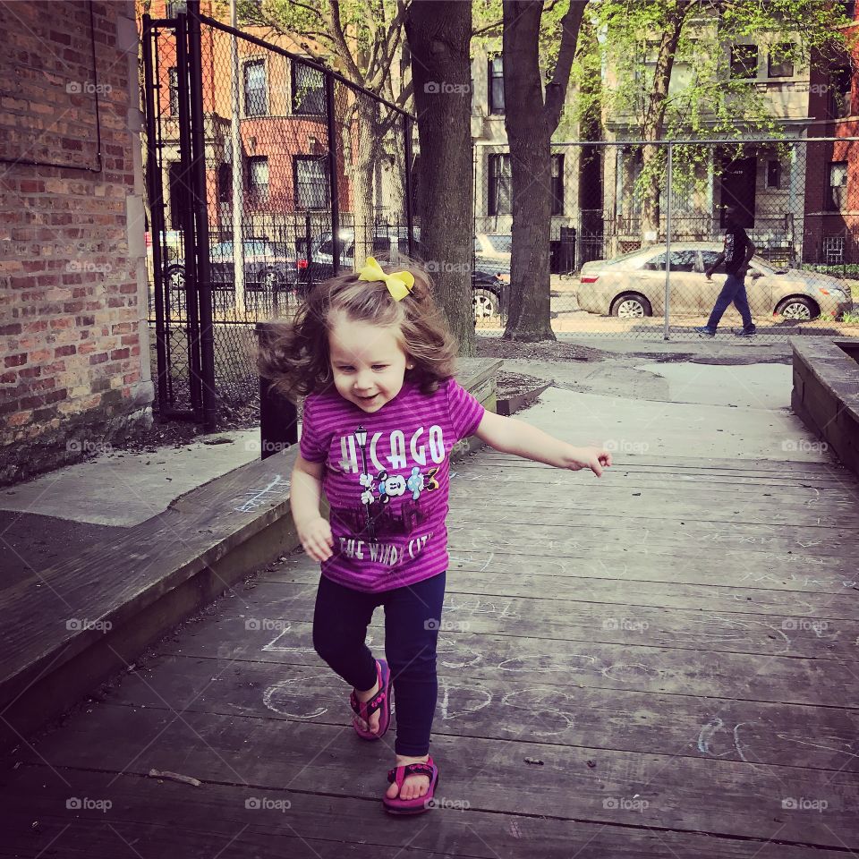 Small girl playing on street