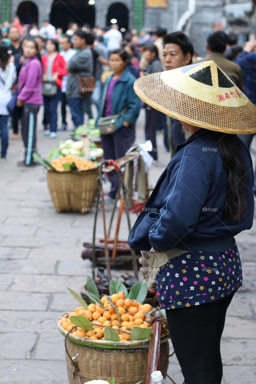 The woman sale some fruit on the street in china 