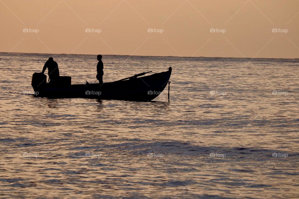 Fishermen boat on sunset 