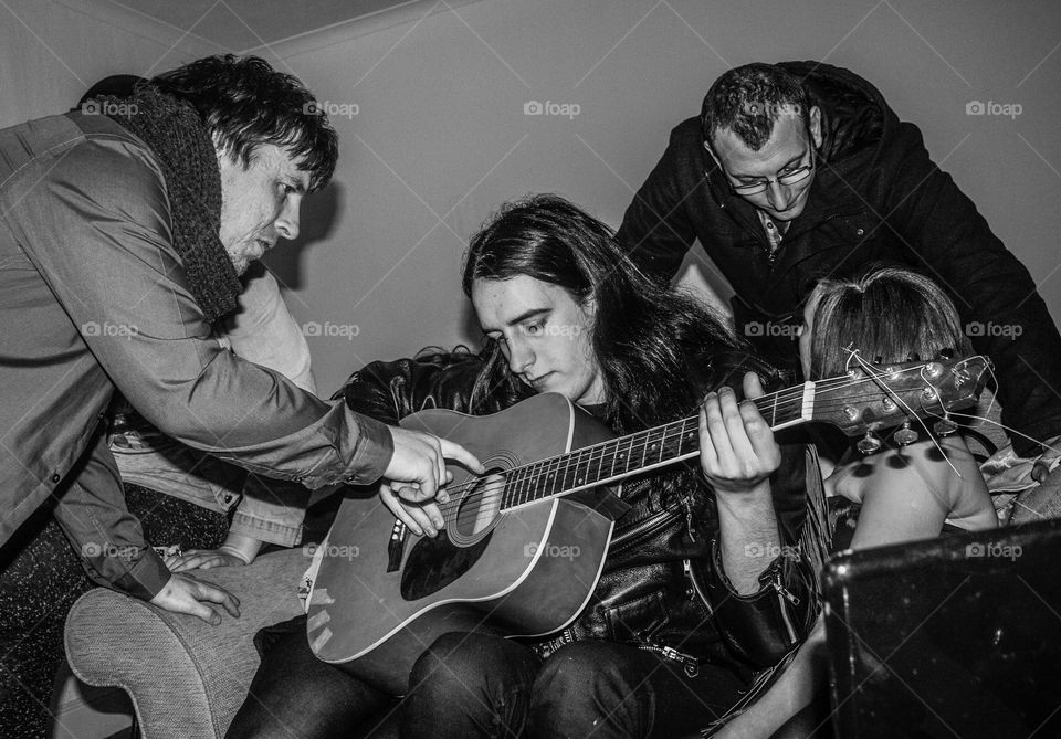 Musicians swap notes, backstage at a gig in Hastings