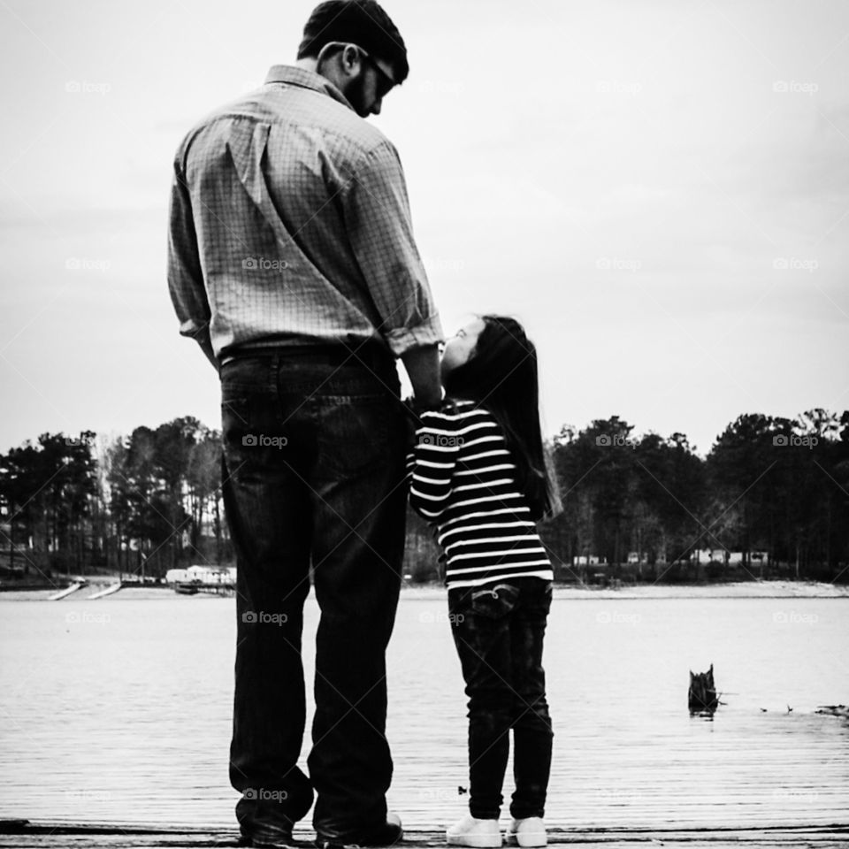 Father and Daughter . Little girl looking up at her Daddy 