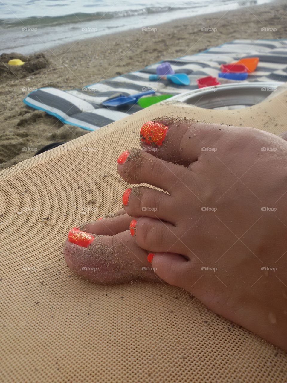 Female nails on the beach