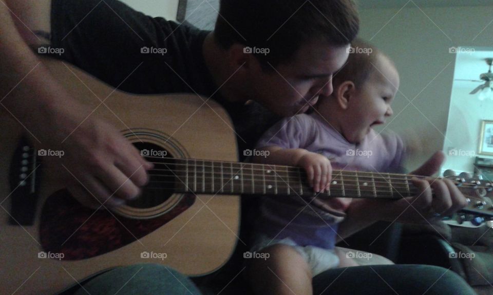 baby guitar dance. wriggling and dancing while daddy plays