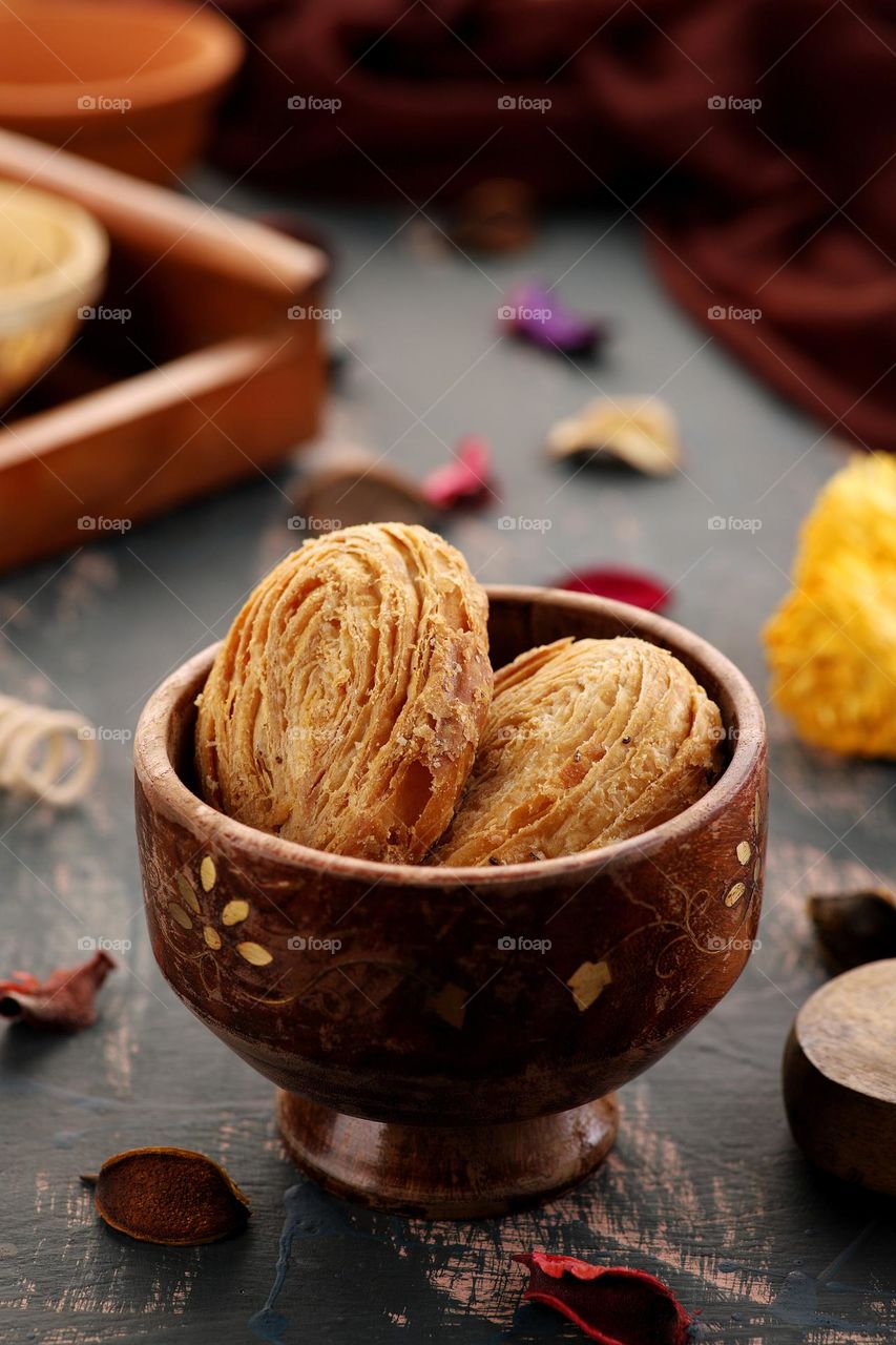 Indian layered cookies in a wooden bowl