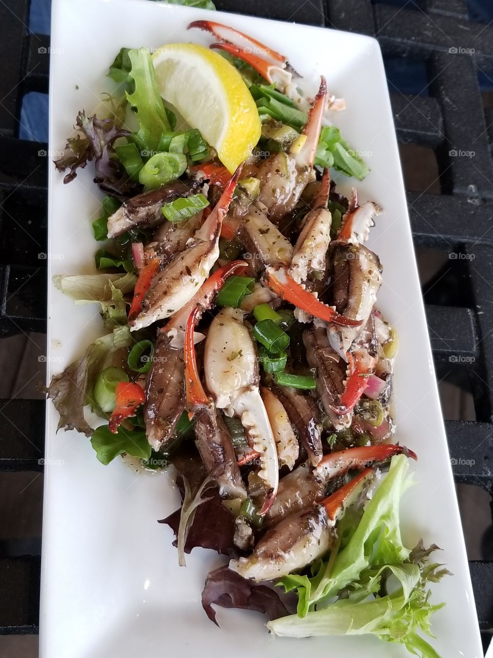 Marinated crab meat over mixed greens